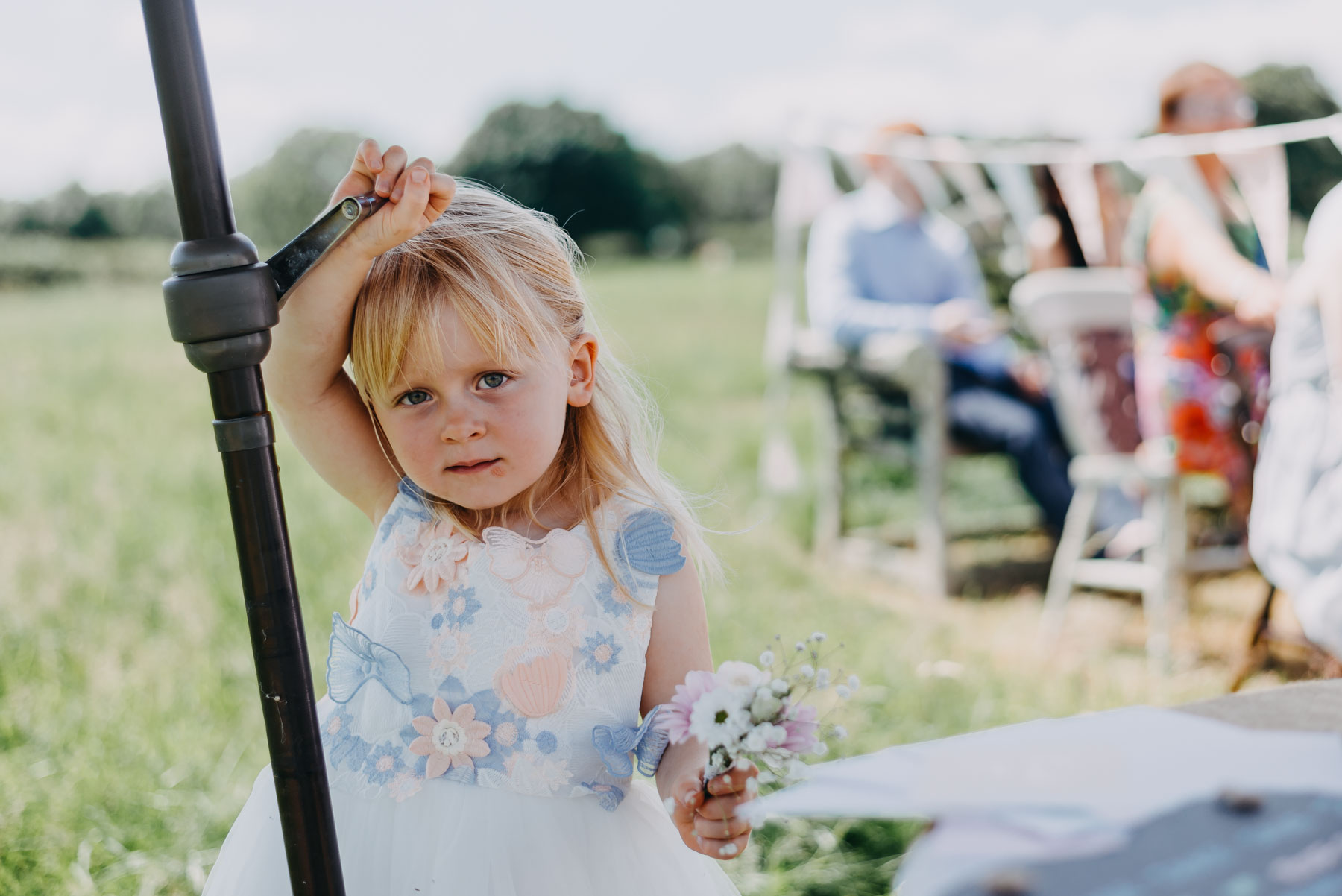 A little girl with flowers at the ceremony of the handfasting