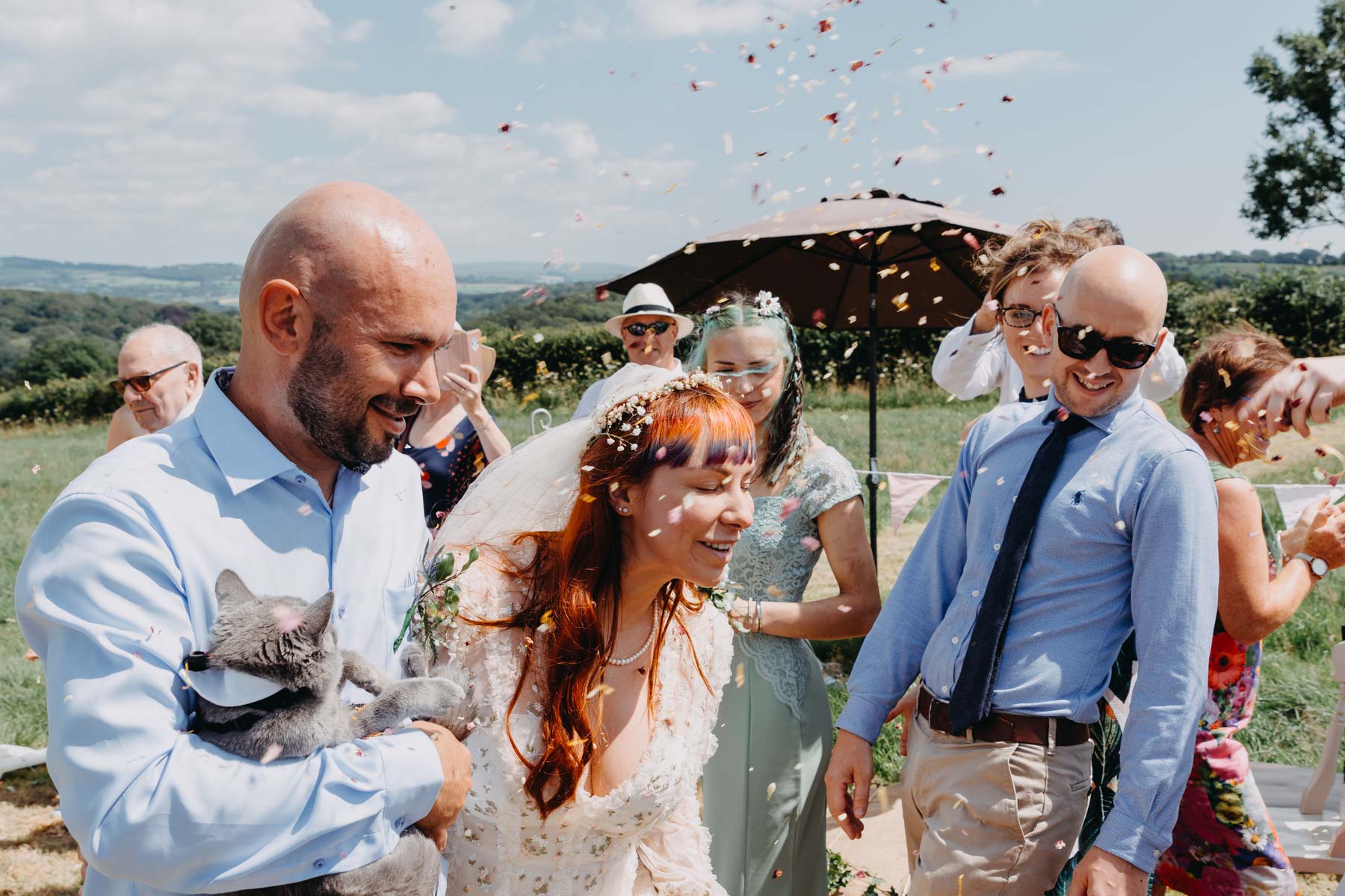 The bride and groom sprinkled with confetti after handfasting ceremony