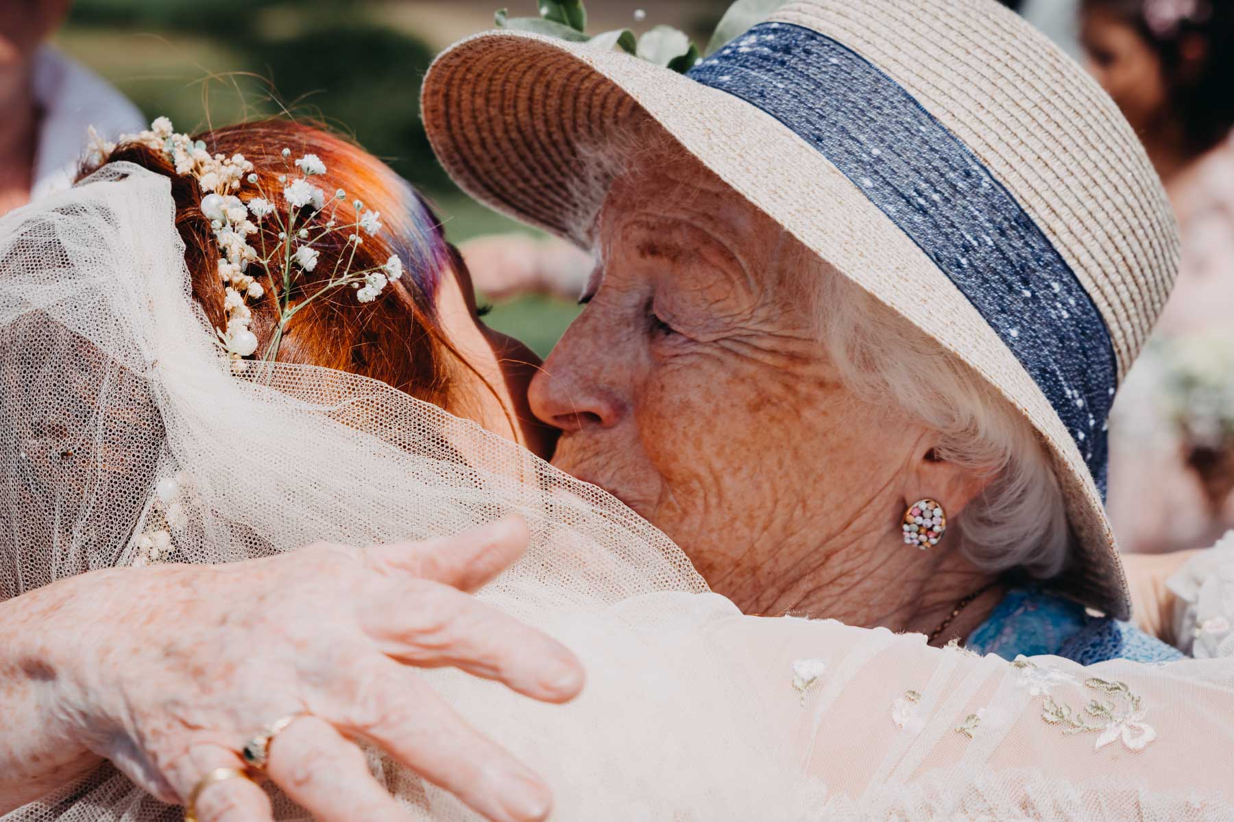 The grandmother kissing the bride