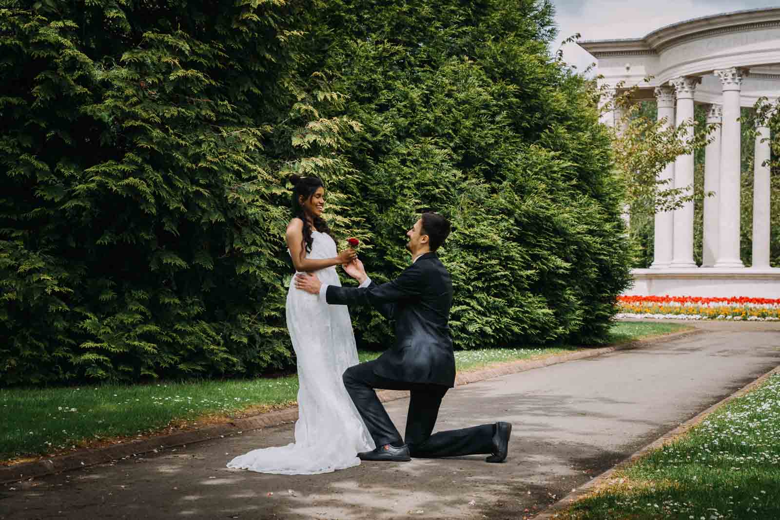 groom kneels on one knee in front of a happy bride in wales - micro wedding photography