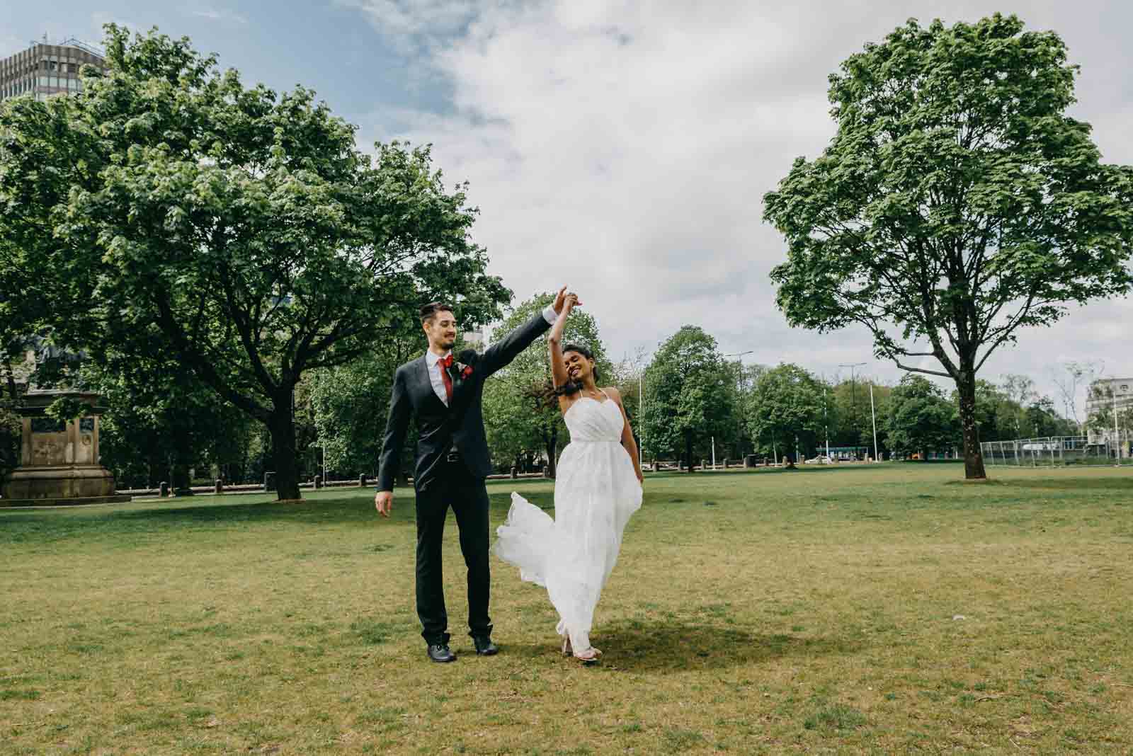 Micro wedding photography Wales - bride and groom dancing in the park