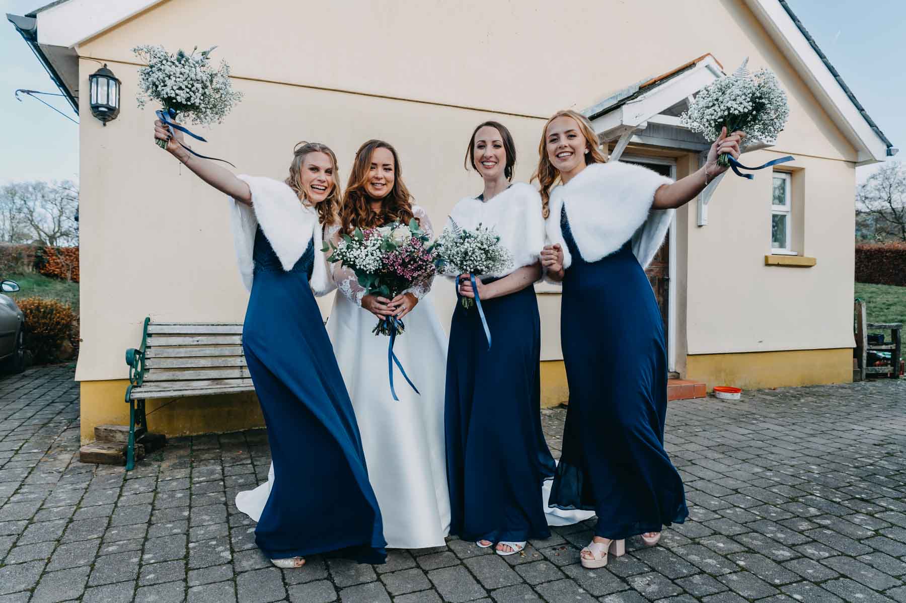 The bride and bridesmaids in fron of the house - natural wedding photography Wales