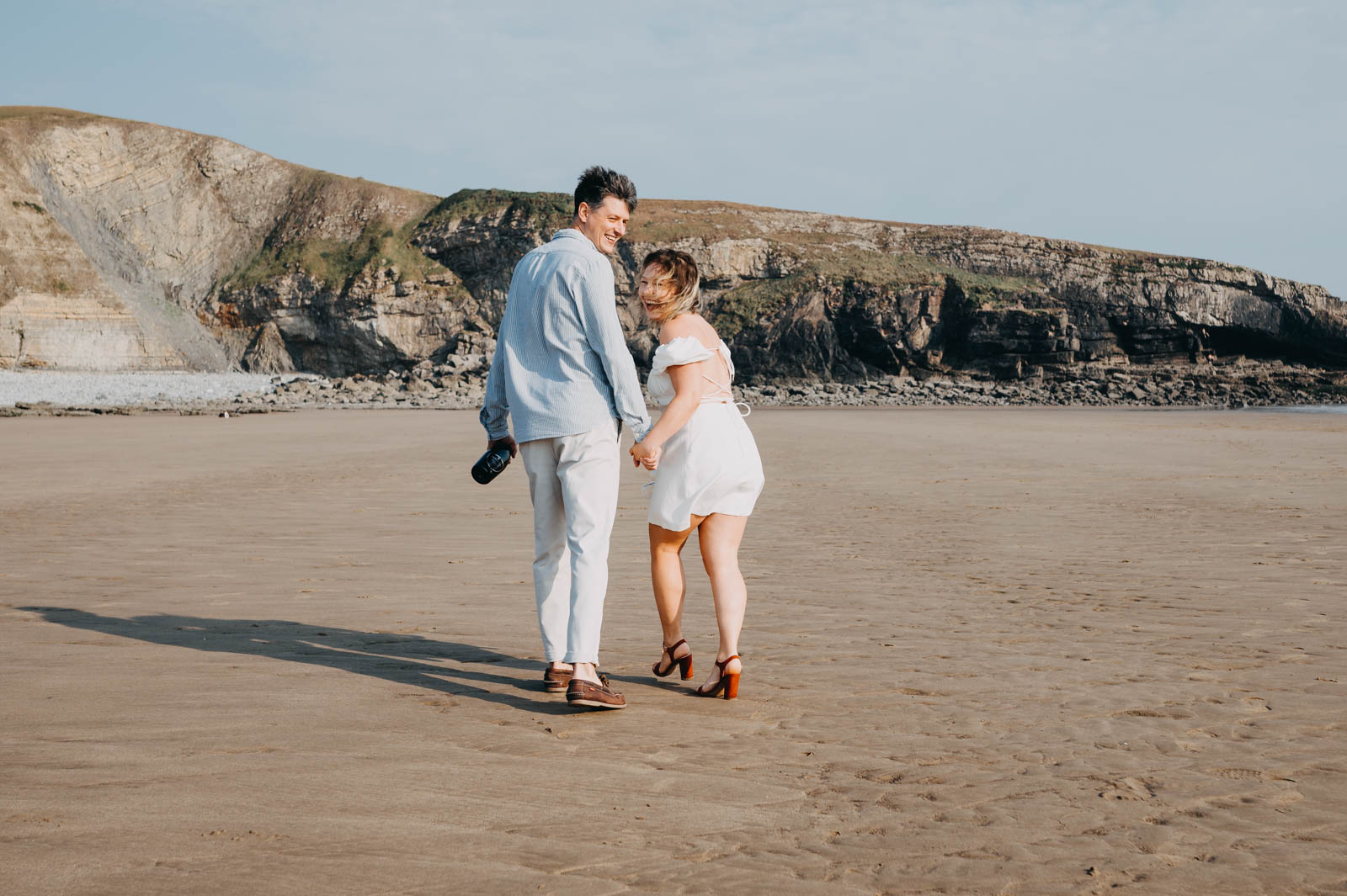 Engagement photoshoot Wales on the beach - smiling couple
