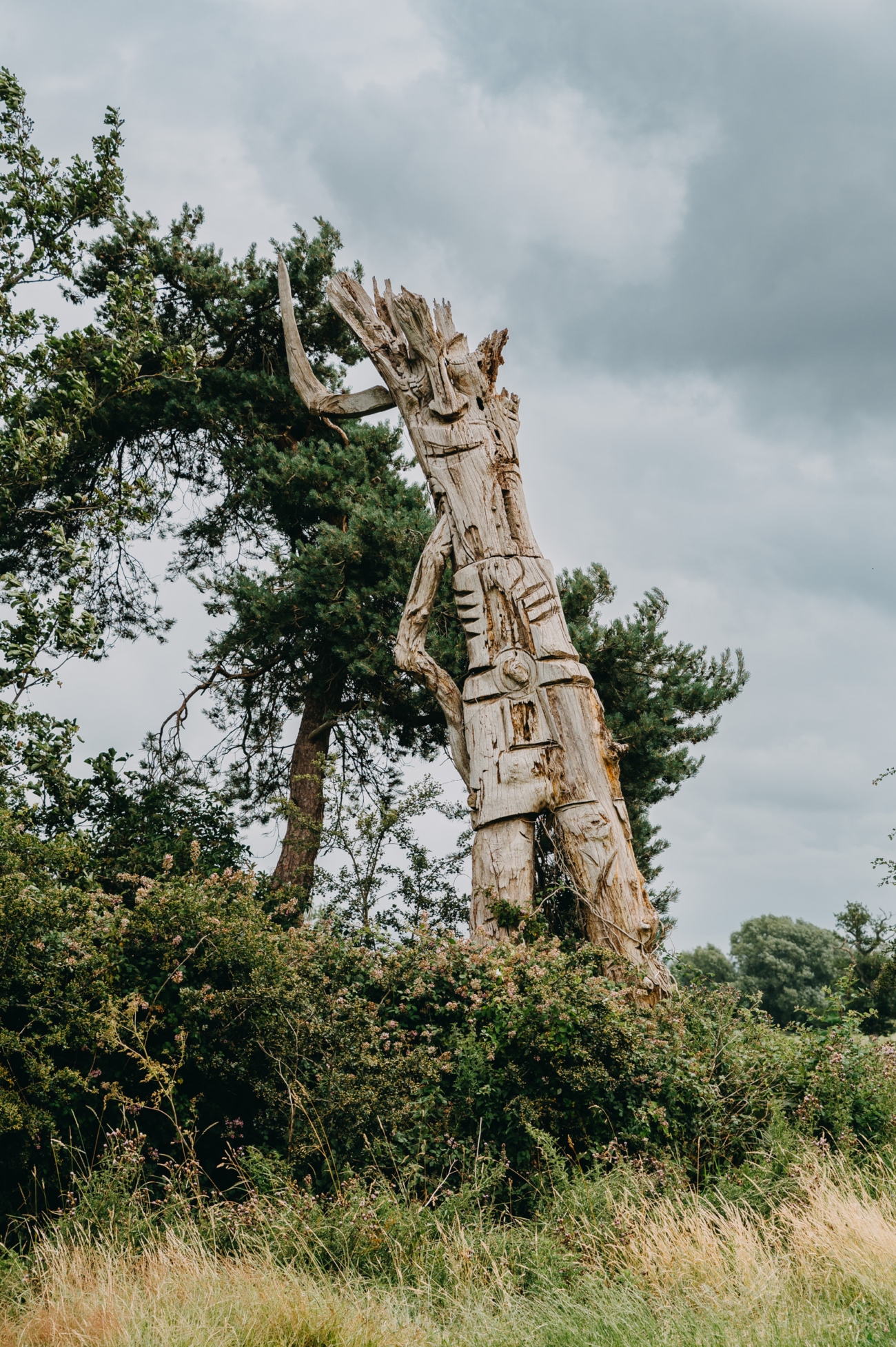 Carved tree sculpture at Splotts Moor, adding a rustic touch to the festival wedding setting in Glastonbury.
