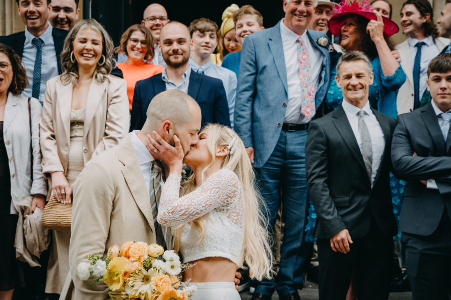 The newlyweds kissing in front of Register Office in Bristol