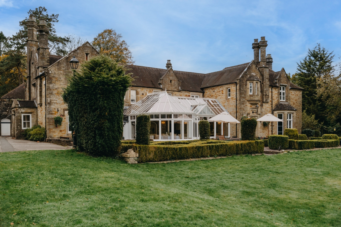 Bryngarw House, a charming wedding venue in South Wales, featuring beautiful gardens and a romantic glass conservatory ideal for intimate ceremonies.