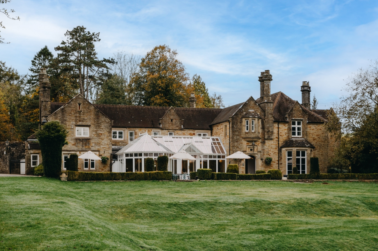 A wide view of Bryngarw House, a romantic wedding venue in South Wales, with its beautiful conservatory and lush green gardens, perfect for outdoor ceremonies and receptions.