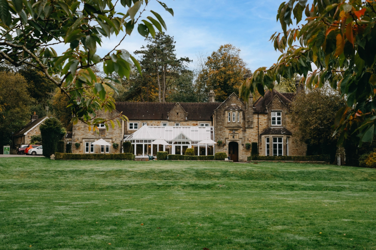 A picturesque view of Bryngarw House, a romantic wedding venue in South Wales, surrounded by greenery and offering a beautiful conservatory for intimate wedding celebrations.
