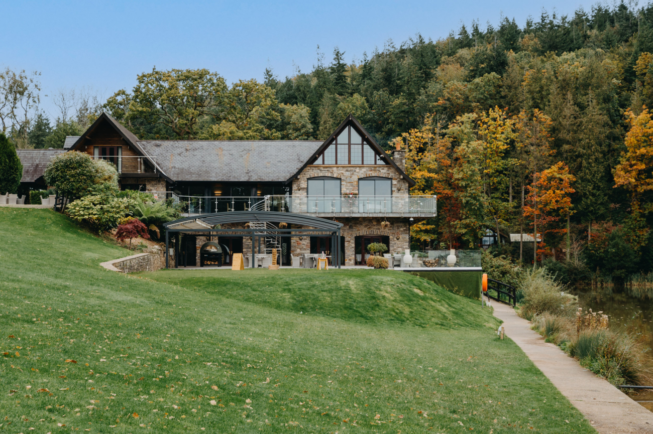 Charming view of Canada Lodge & Lake, a stunning lakeside wedding venue surrounded by lush forests, perfect for couples seeking a romantic and secluded setting for their special day.