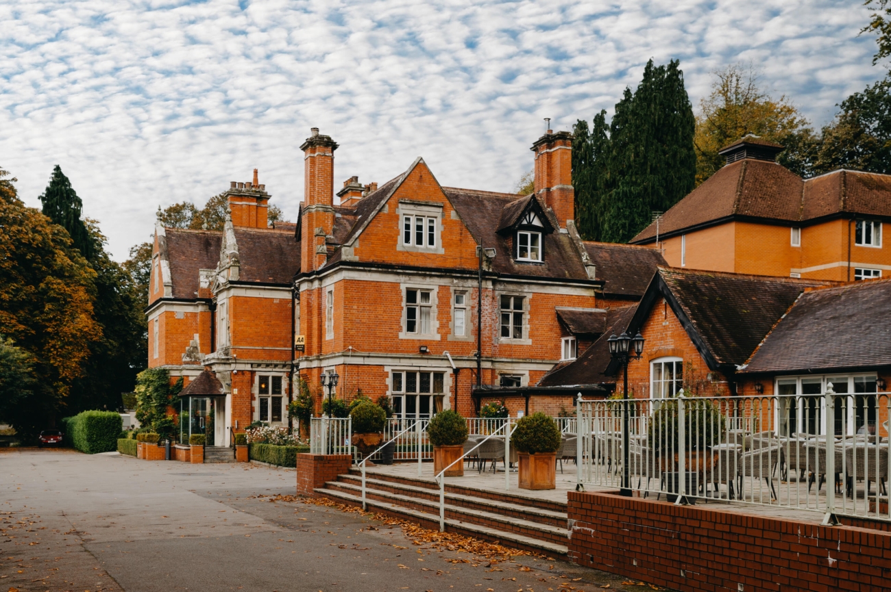 View of the patio and terrace at Coed-Y-Mwstwr Hotel near Bridgend, featuring outdoor seating perfect for an elegant wedding reception in the scenic Welsh countryside.