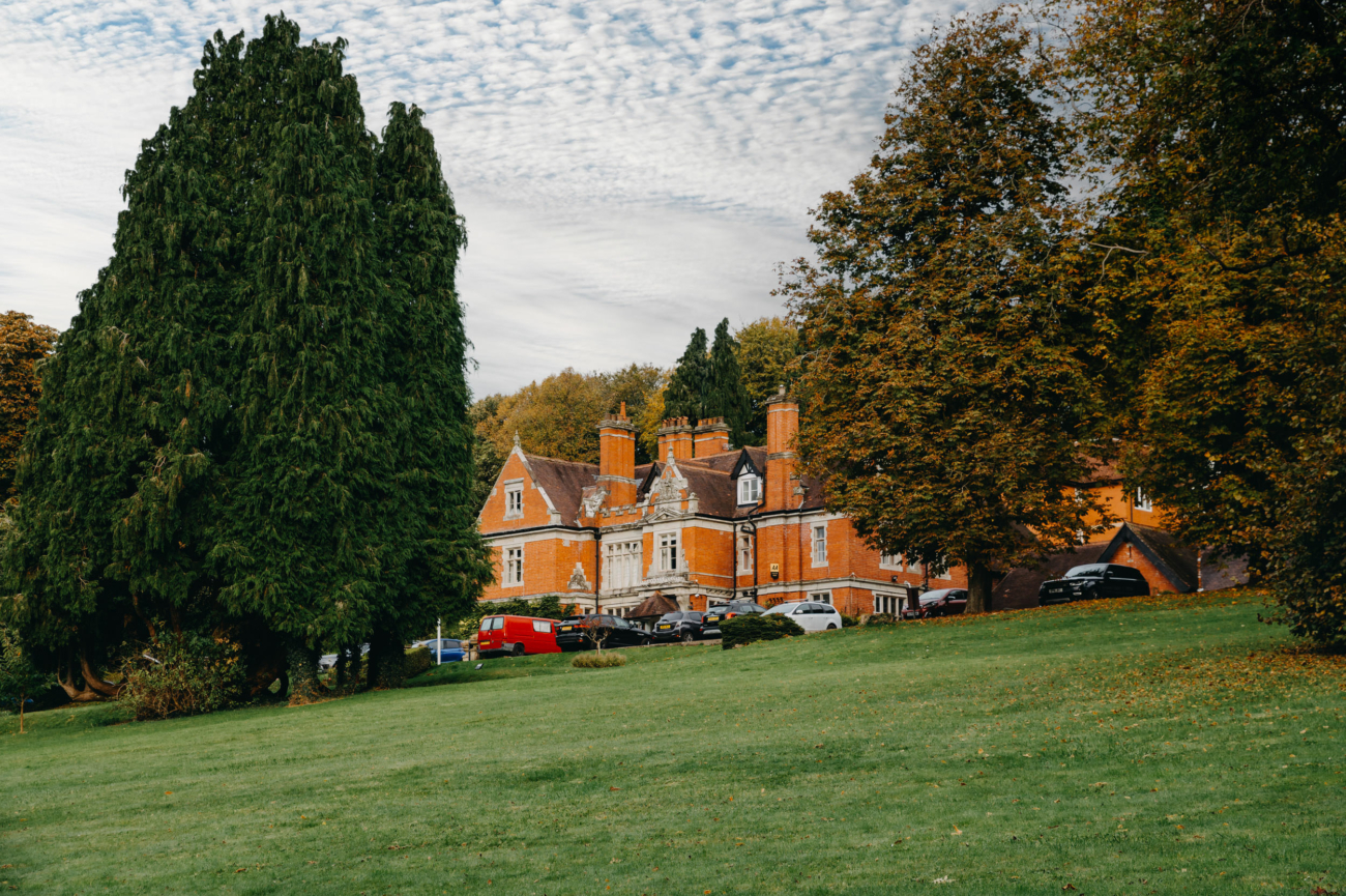 Coed-Y-Mwstwr Hotel near Bridgend, surrounded by lush green grounds and towering trees, providing a serene and private setting for a Welsh countryside wedding.