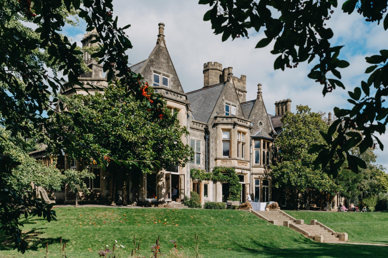 Victorian architecture of Insole Court, a romantic wedding venue in Cardiff, set against a lush green garden backdrop, ideal for an elegant outdoor ceremony.