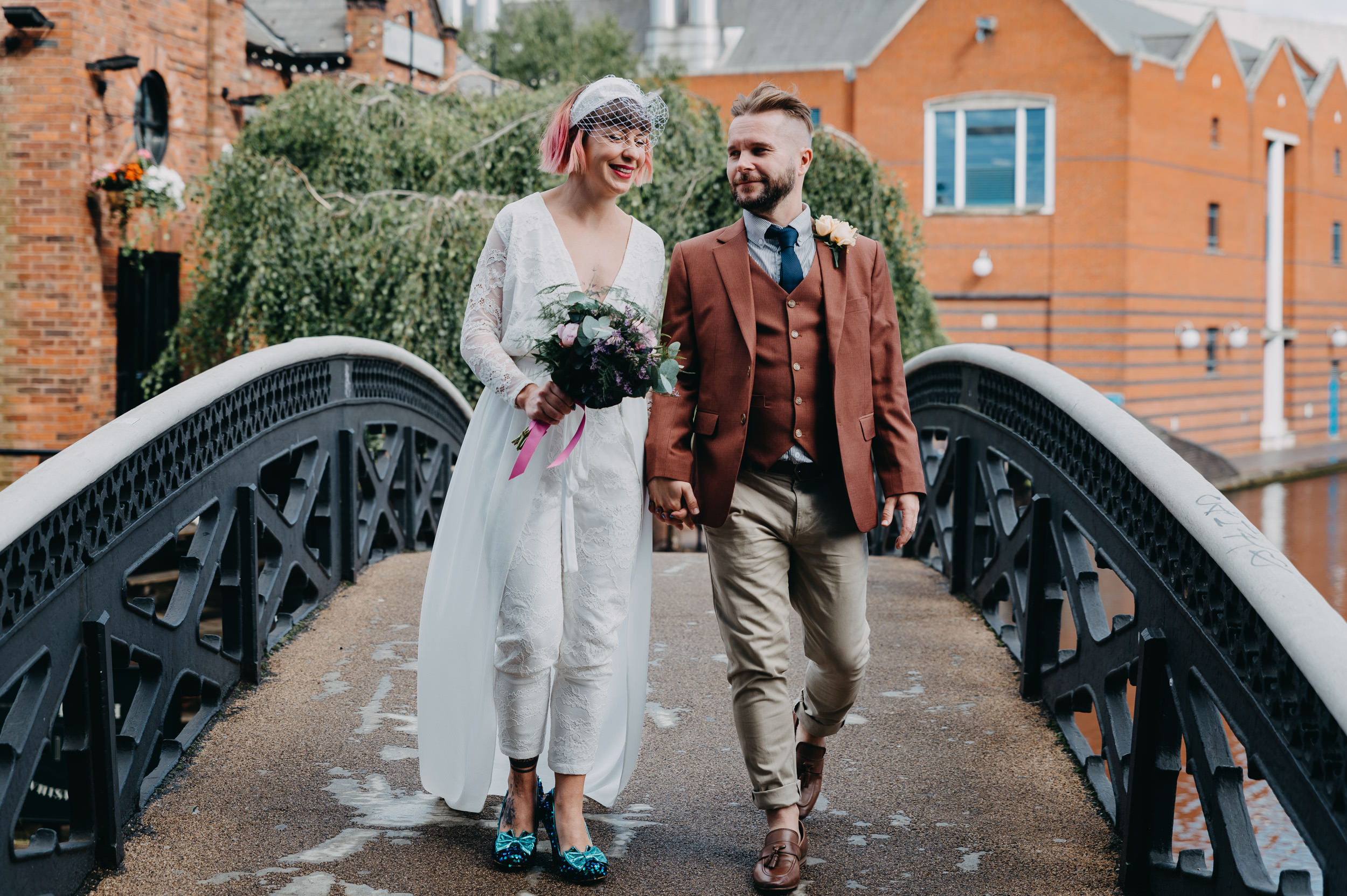 Couple crossing a bridge on their wedding day, showcasing authentic wedding photography