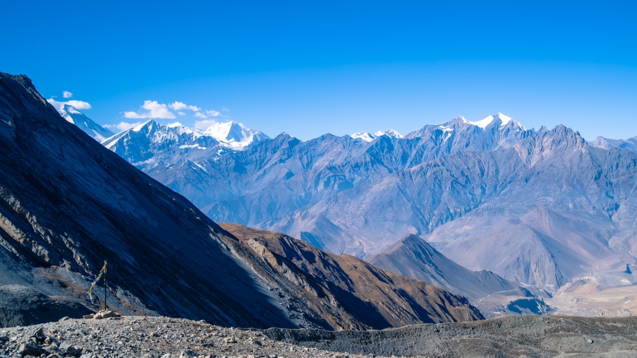 Descending from Thorong La pass with the Dhaulagiri range in the background.