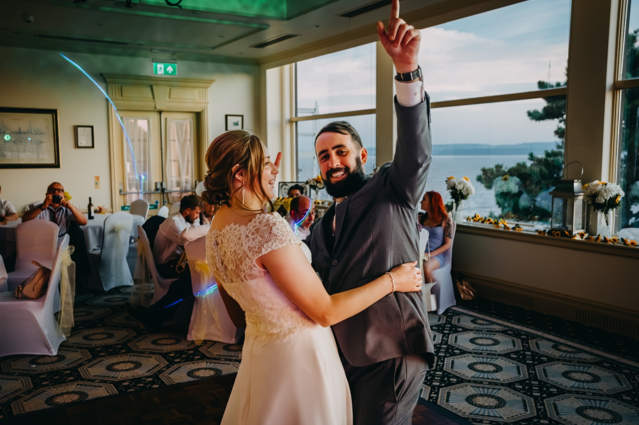The couple dance joyfully at their wedding reception overlooking the sea at the Imperial Hotel Torquay.