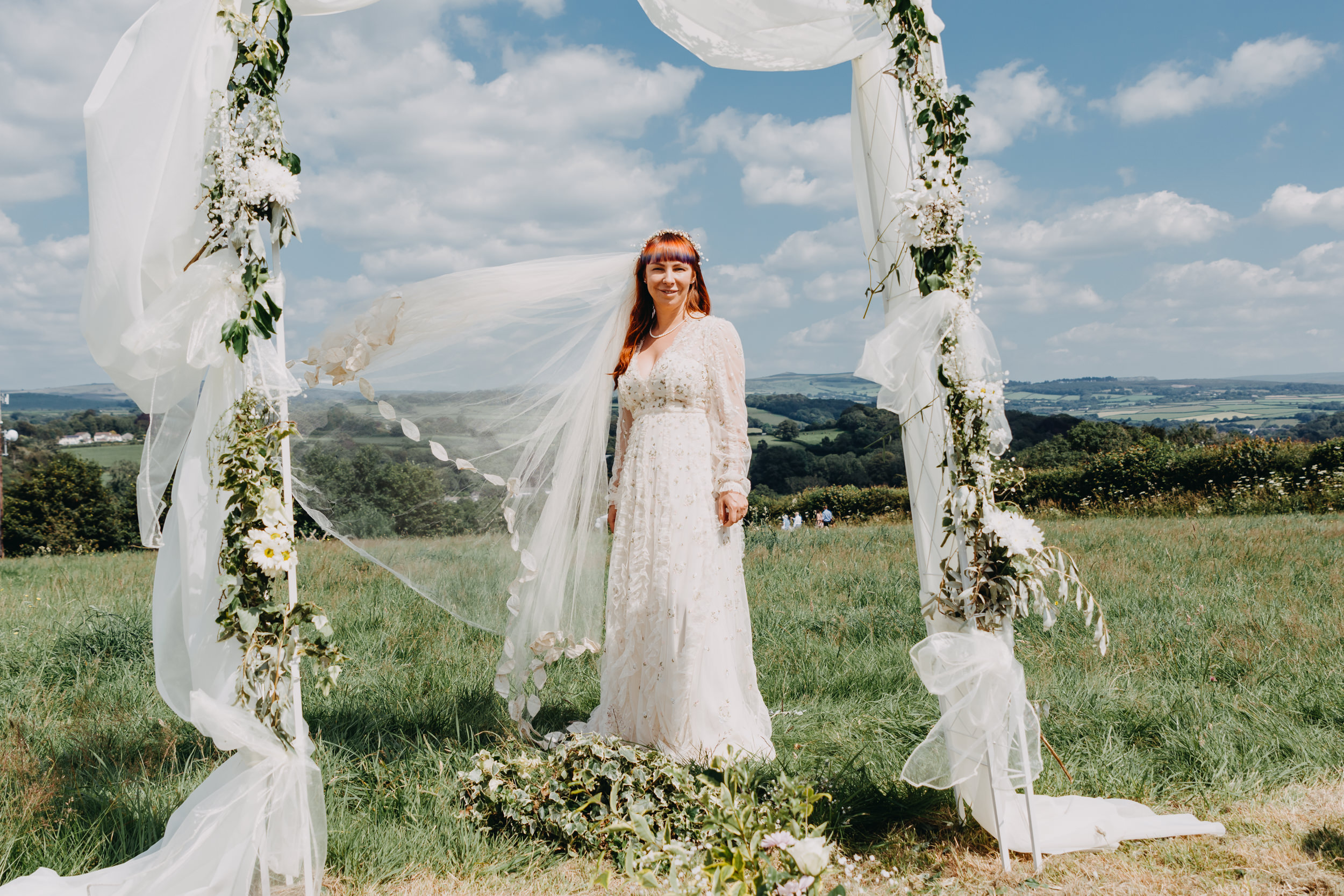 Bride with floating veil during a quiet moment captured as part of creative wedding portraits