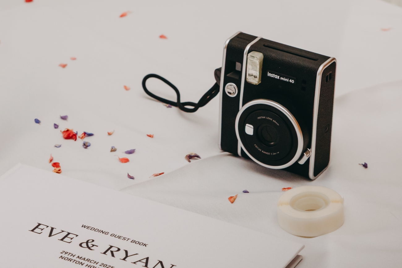 Instax camera on a wedding guest table – symbolic reminder that not everyone with a camera is a wedding photographer