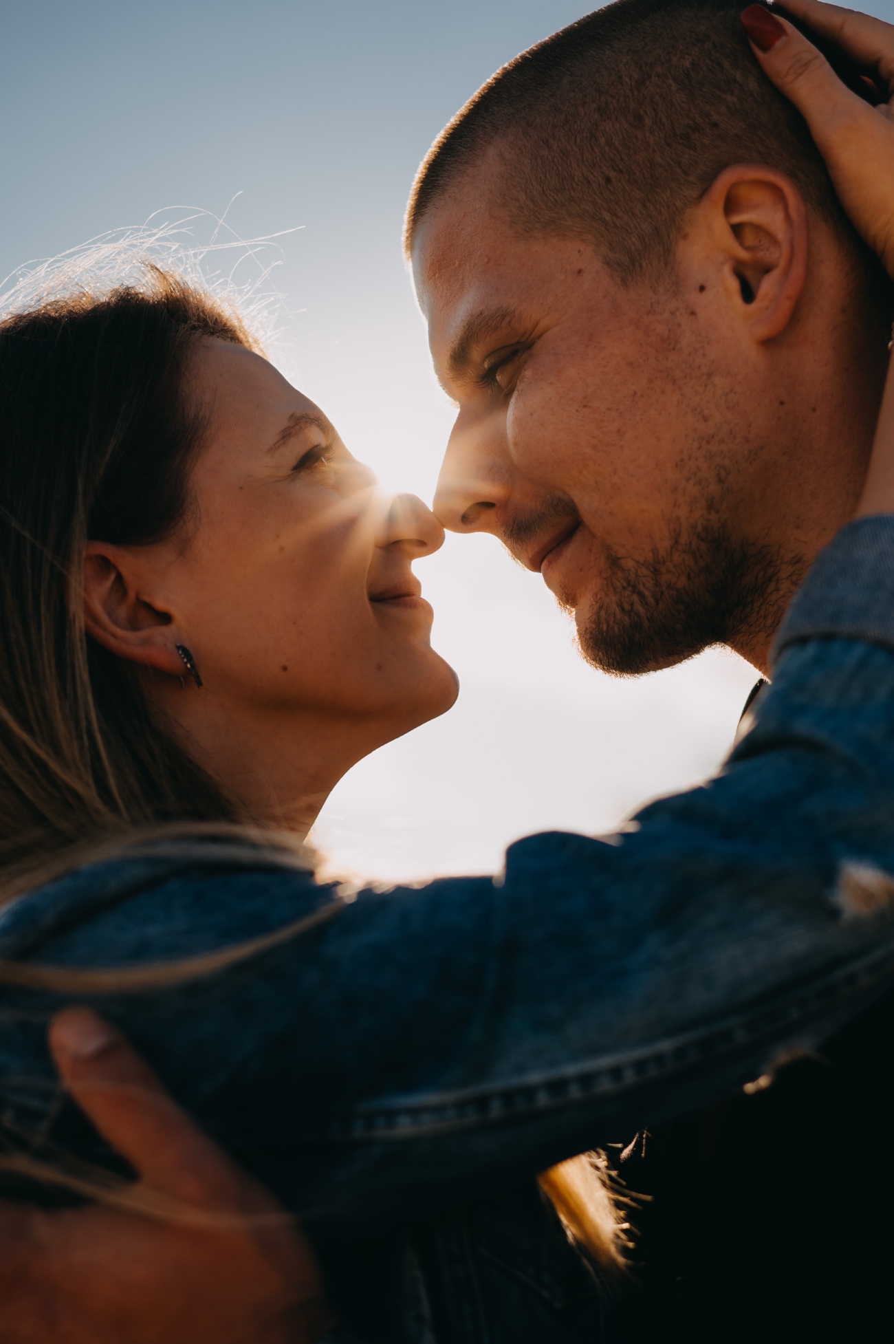 Candid couple photoshoot close-up with natural sunlight and eye contact