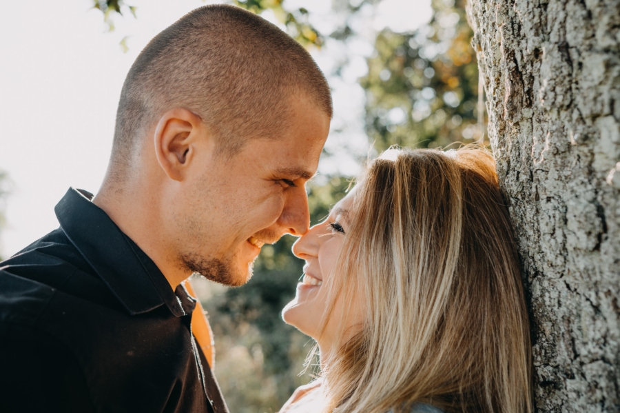 Candid couple photoshoot outdoors with natural light and real smiles