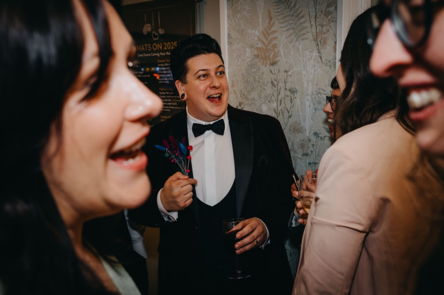 Lively candid wedding moment captured during reception drinks – South Wales documentary wedding photography