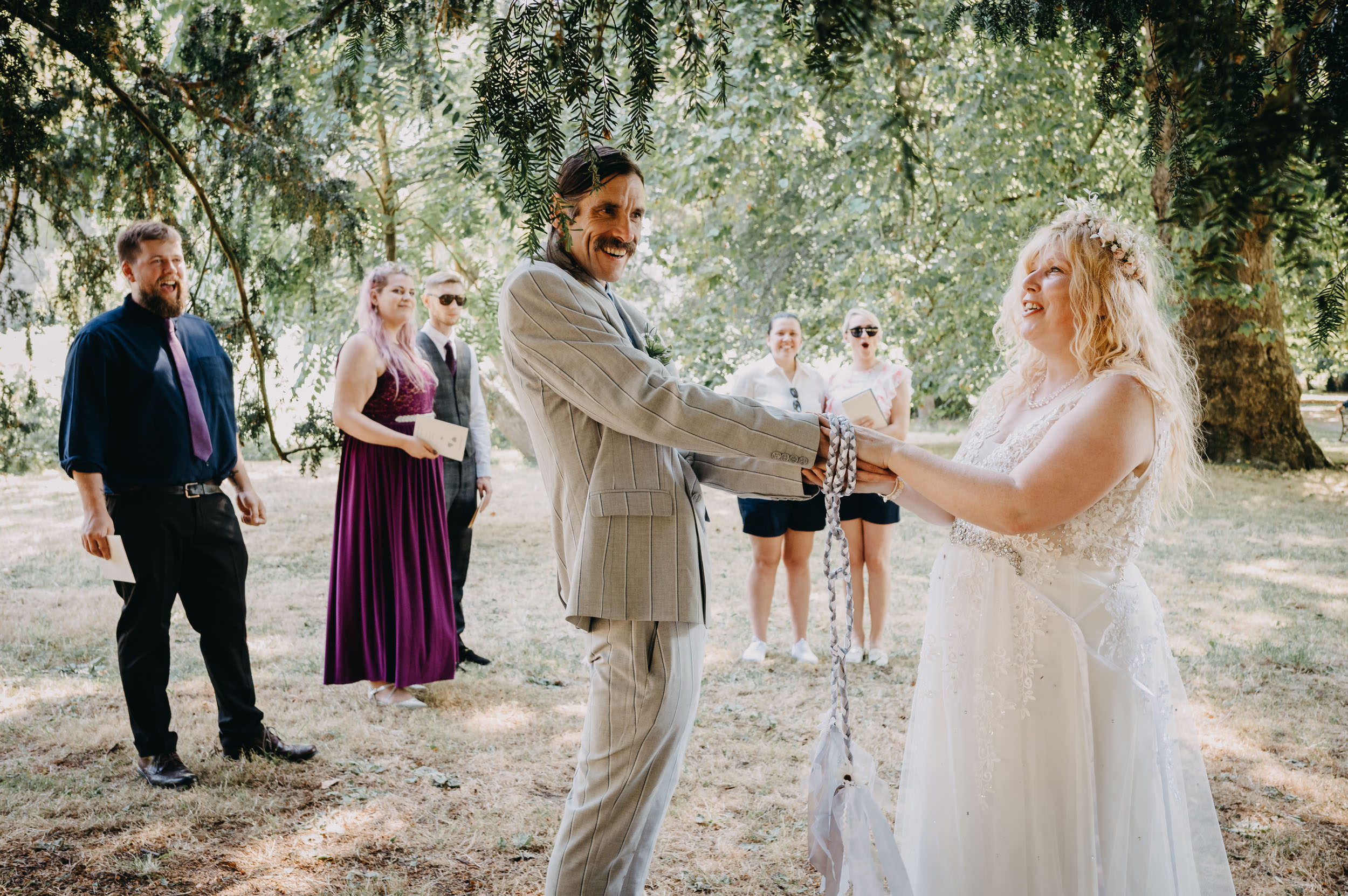 Handfasting ceremony during a non-traditional wedding in a Cardiff park — joyful, personal and deeply meaningful