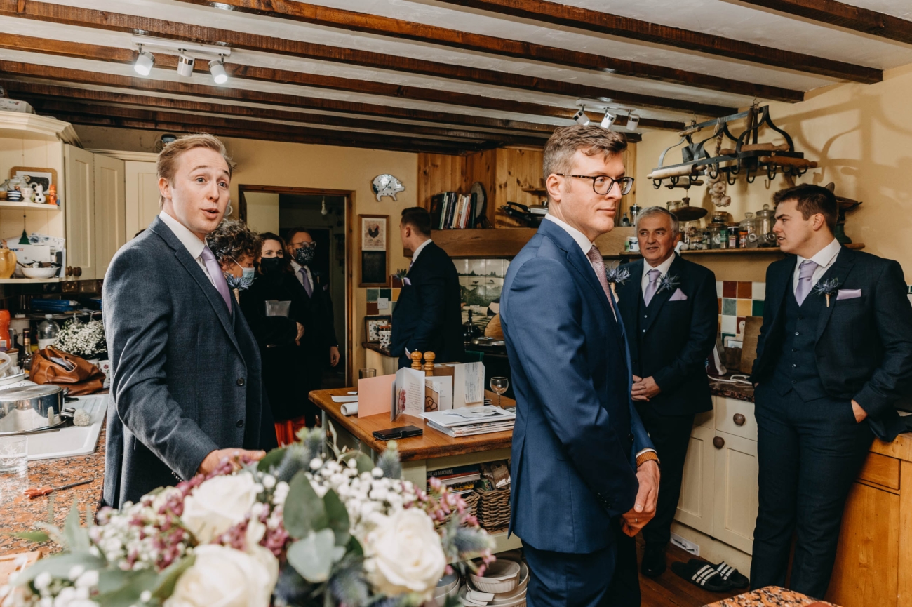 Groom and groomsmen gathered at home before the wedding in Myddfai – informal candid moment in the kitchen