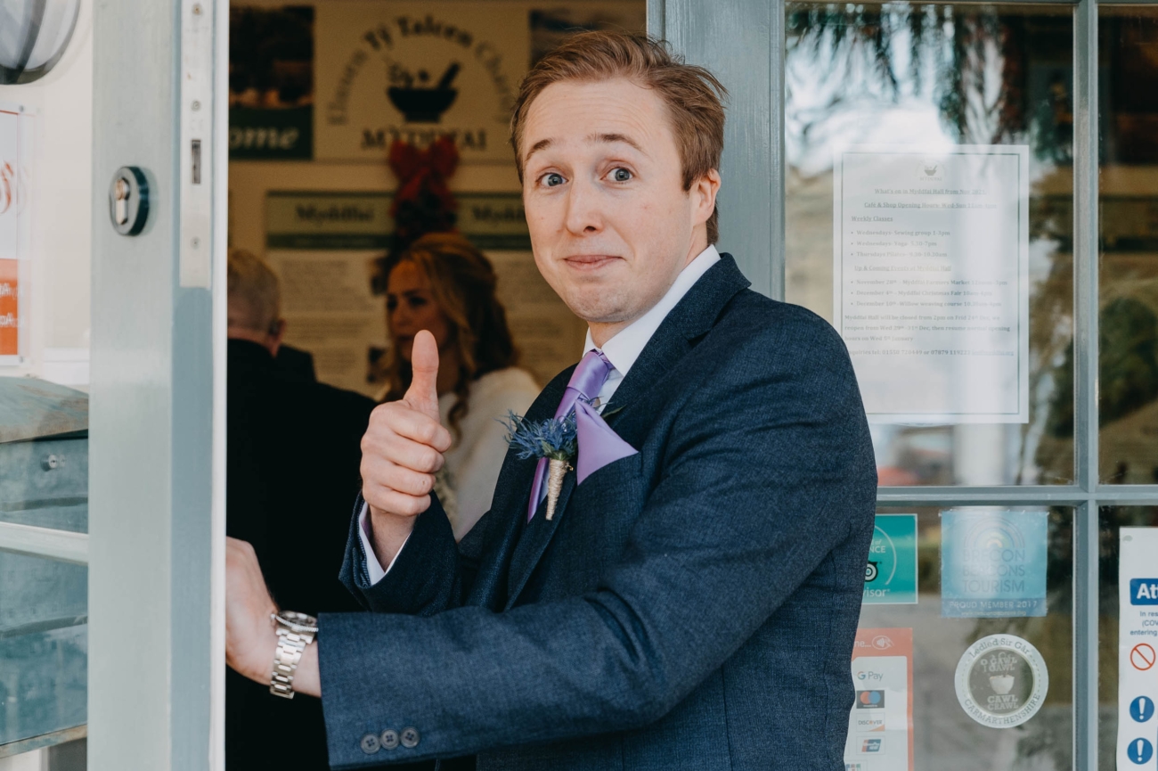 Groom giving a thumbs up at Myddfai Community Hall before the wedding ceremony