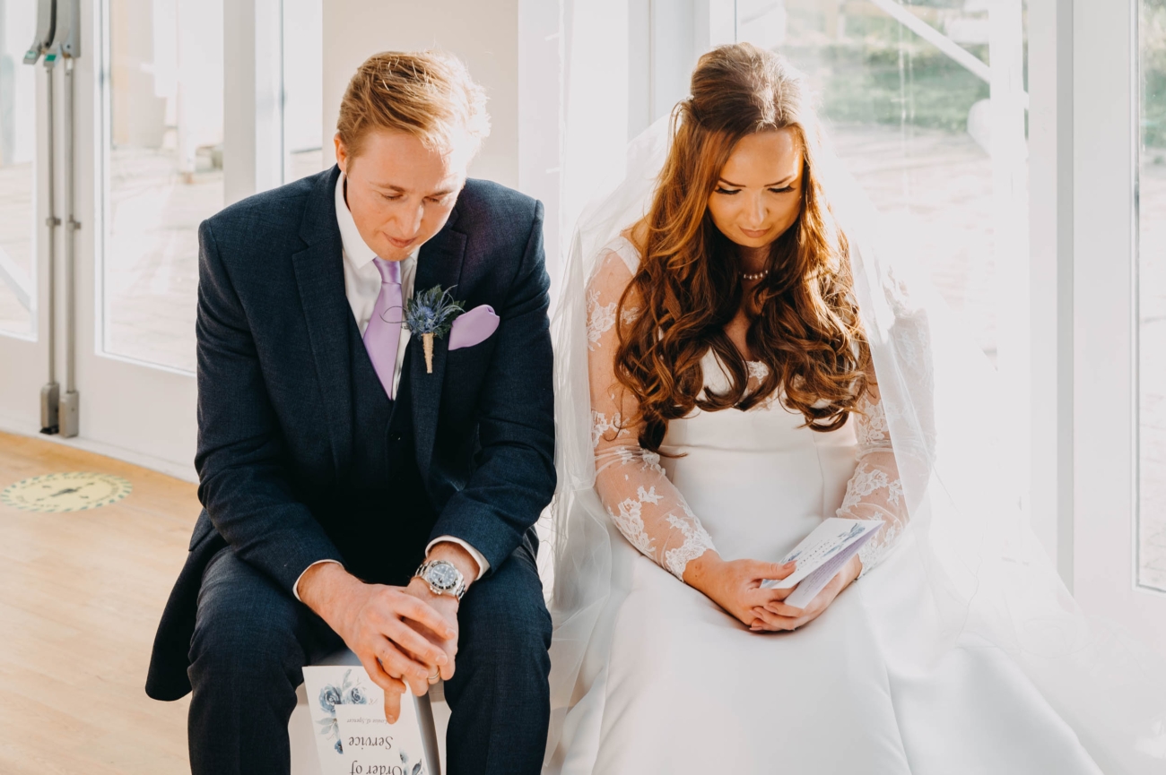 Bride and groom in a quiet moment of reflection during their wedding ceremony in Myddfai