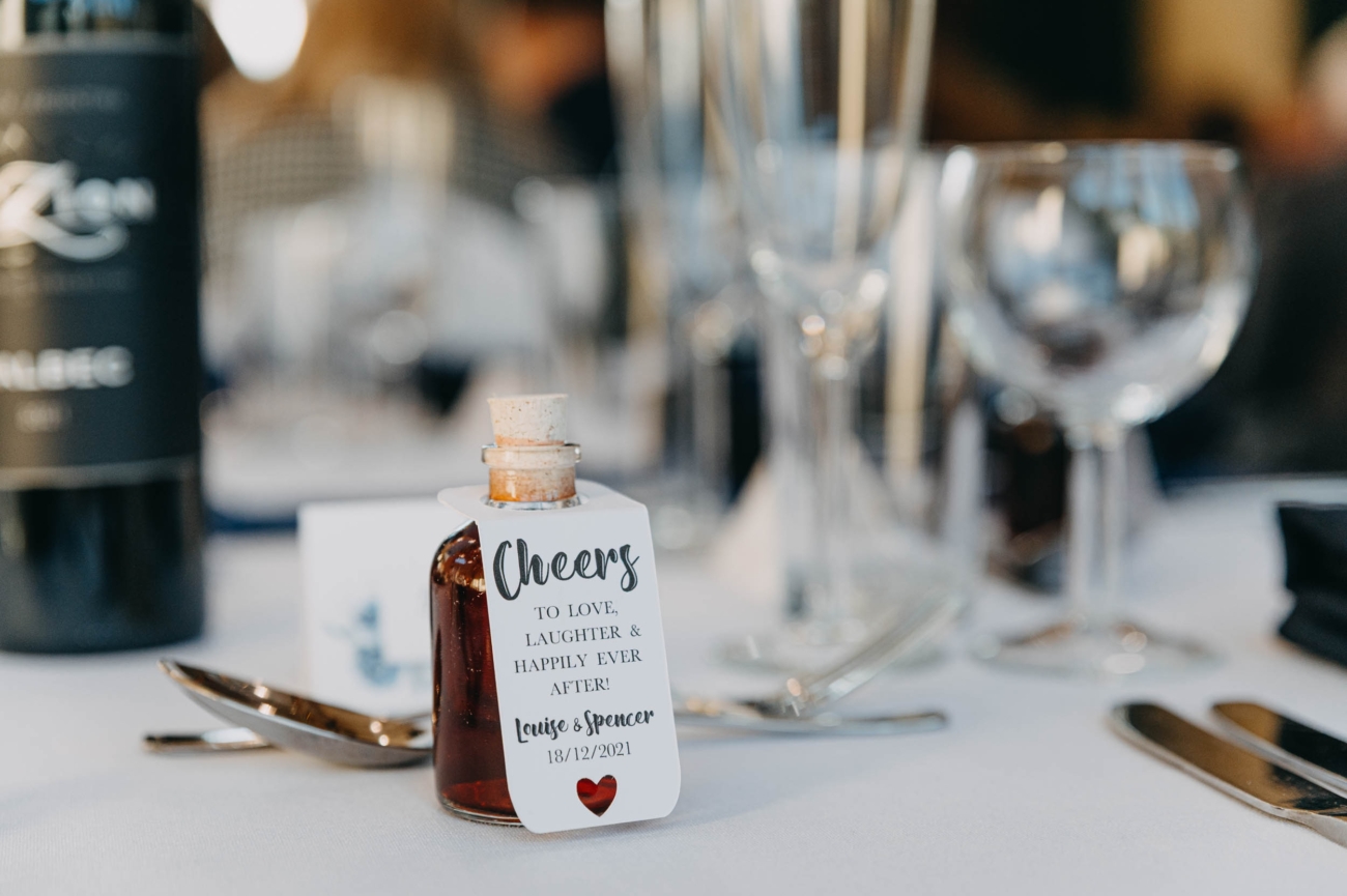 Personalised wedding favour bottle on the reception table at a Myddfai wedding celebration