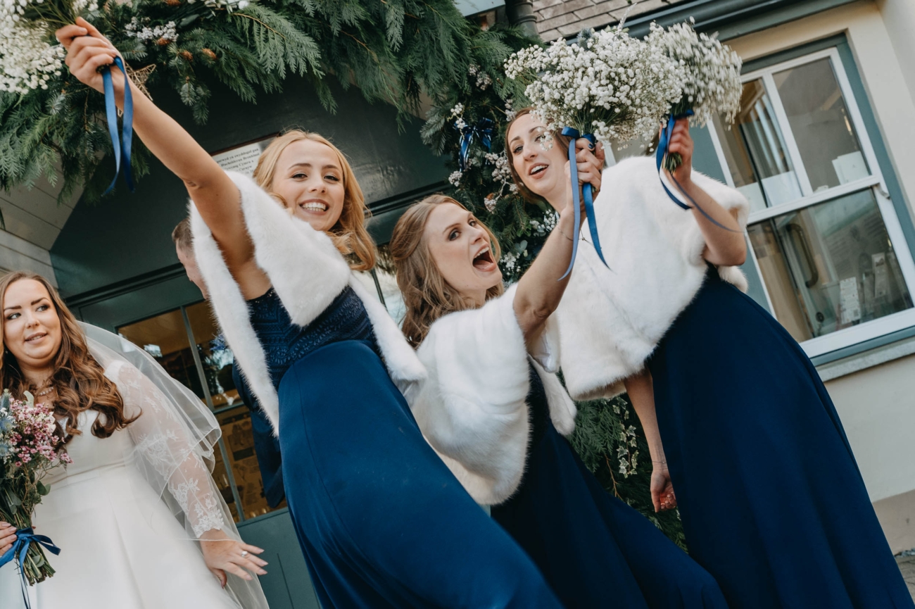 Bridesmaids celebrating outside Myddfai Community Hall after the ceremony – spontaneous and candid wedding moment