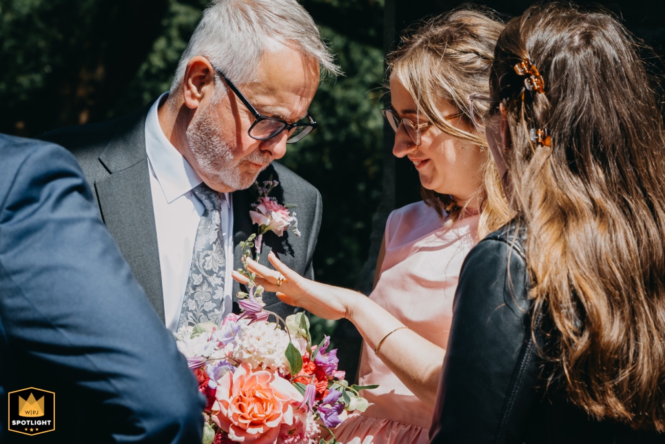 Wedding guest admiring ring during candid outdoor moment – WPJA Glamorgan Spotlight feature