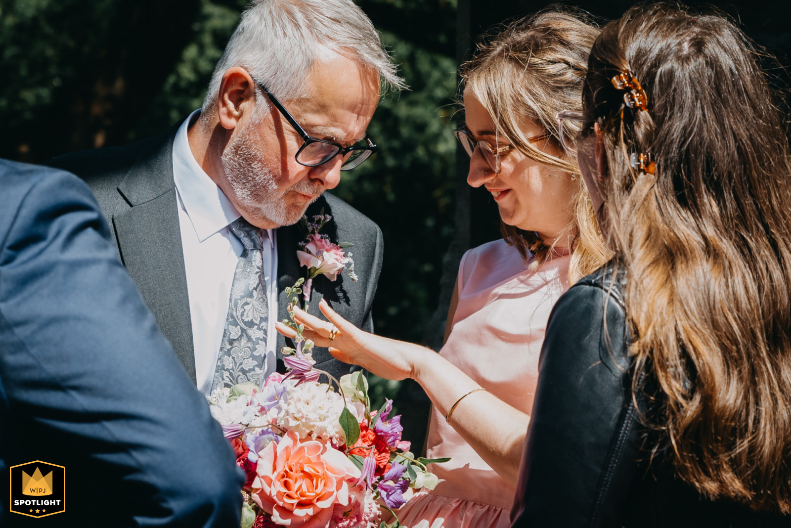 Wedding guest admiring ring during candid outdoor moment – WPJA Glamorgan Spotlight feature