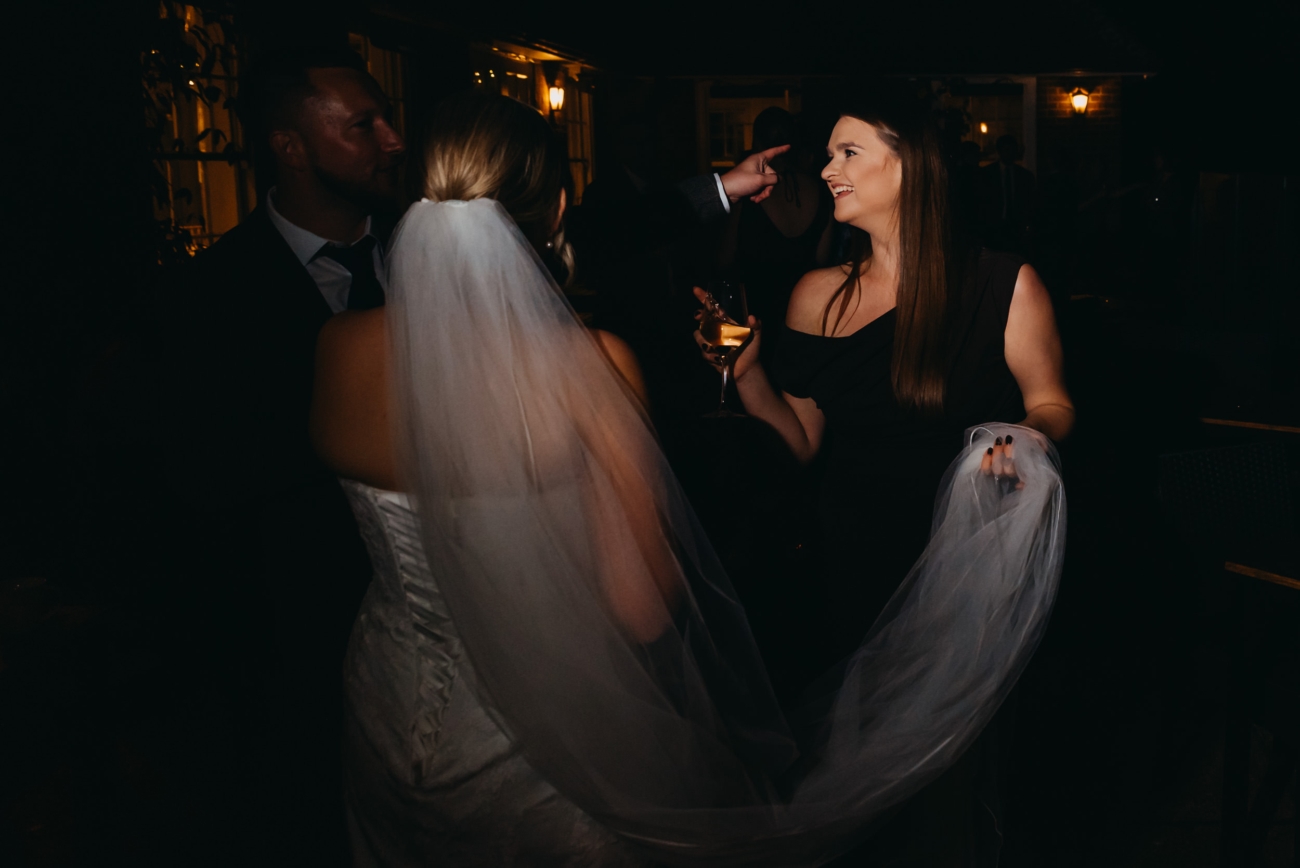 Guests talking naturally during an evening wedding reception