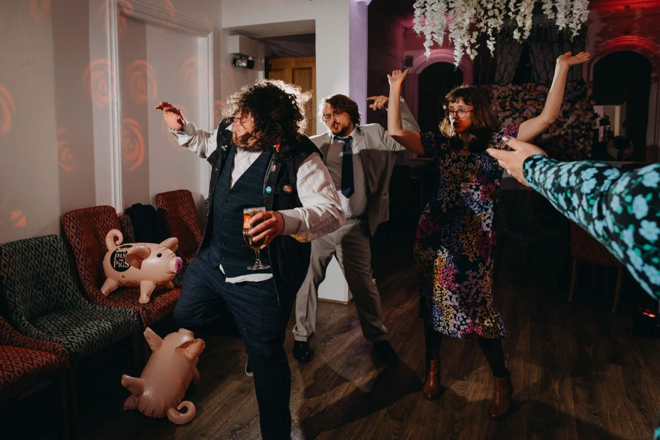 Guests dancing and celebrating on the wedding dance floor during evening documentary wedding coverage