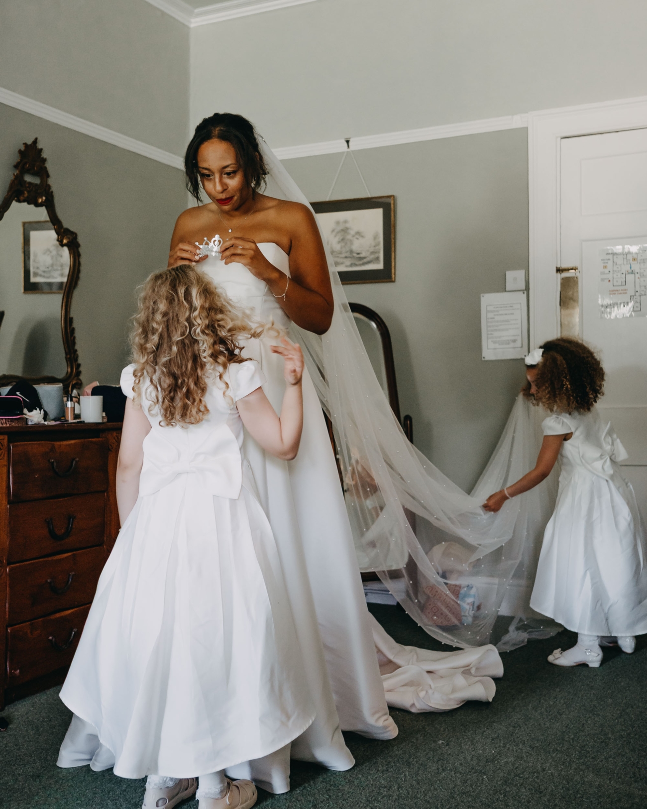 Bride getting ready with flower girls during morning wedding preparations captured in documentary wedding photography style