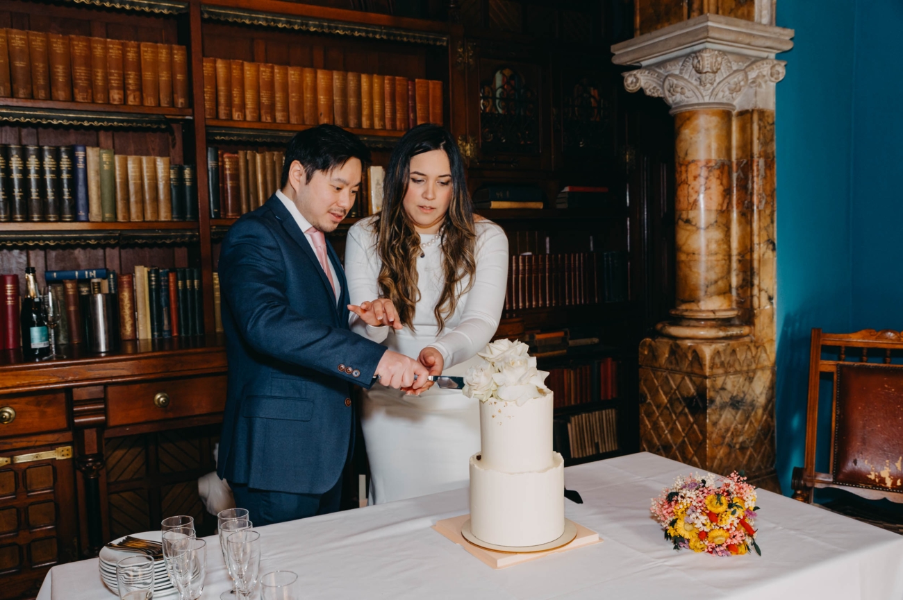 Couple cutting their wedding cake during the reception
