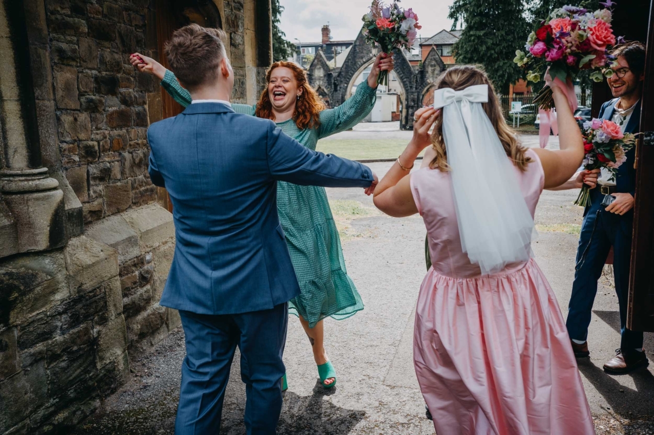 Guests celebrating and hugging after a wedding ceremony in Cardiff