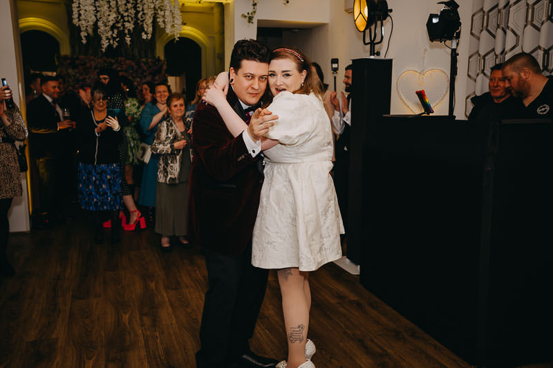 candid wedding reception moment on the dance floor with guests celebrating