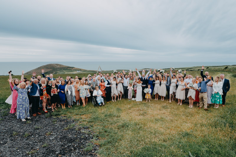 outdoor wedding in South Wales coastal venue with guests celebrating