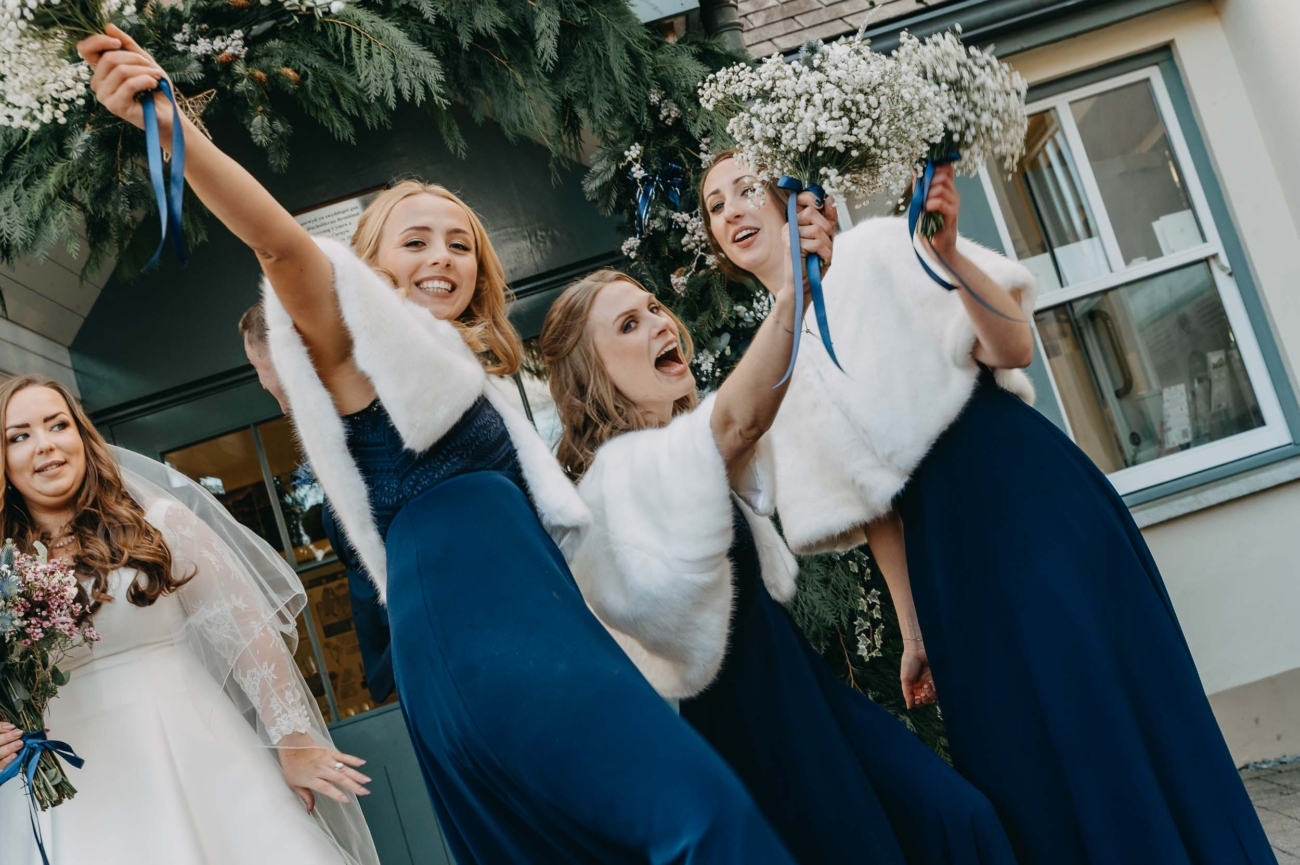 bridesmaids celebrating outside a venue in South Wales captured by a candid wedding photographer