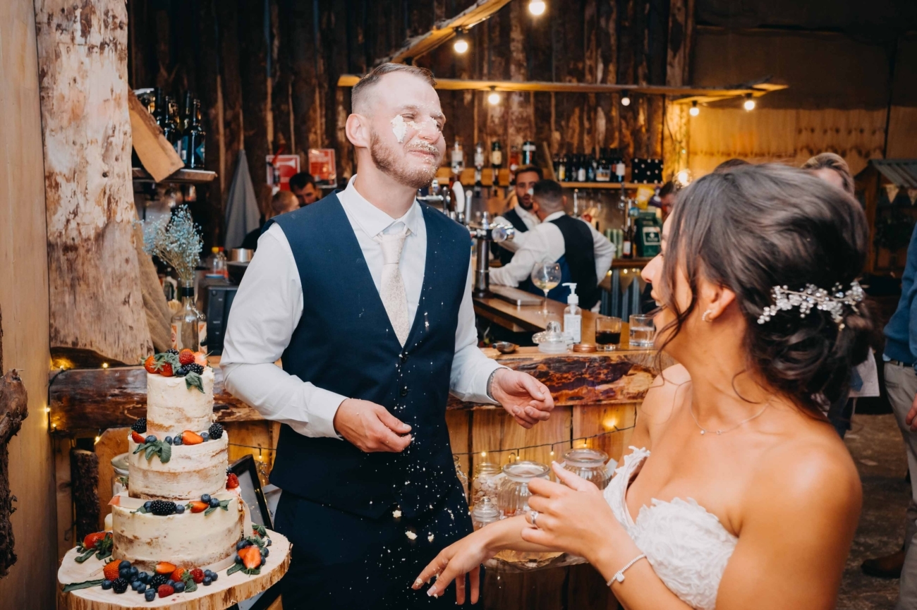 playful cake smash at a South Wales wedding captured in a candid photography style