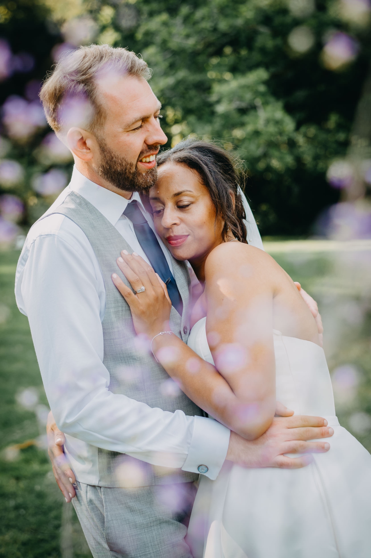 candid moment captured by a South Wales wedding photographer as a couple embraces