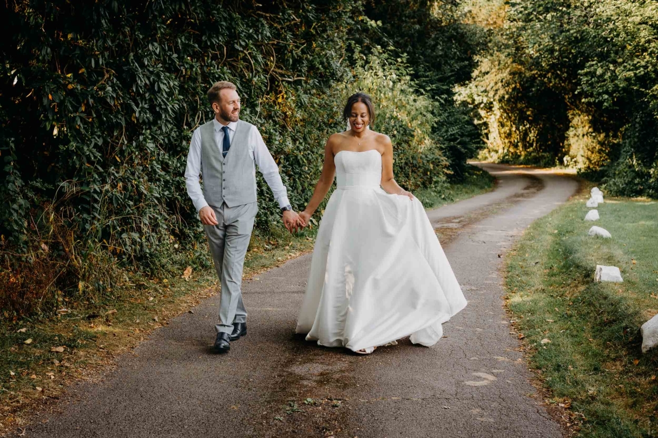 bride and groom walking through the countryside in South Wales photographed in a documentary style