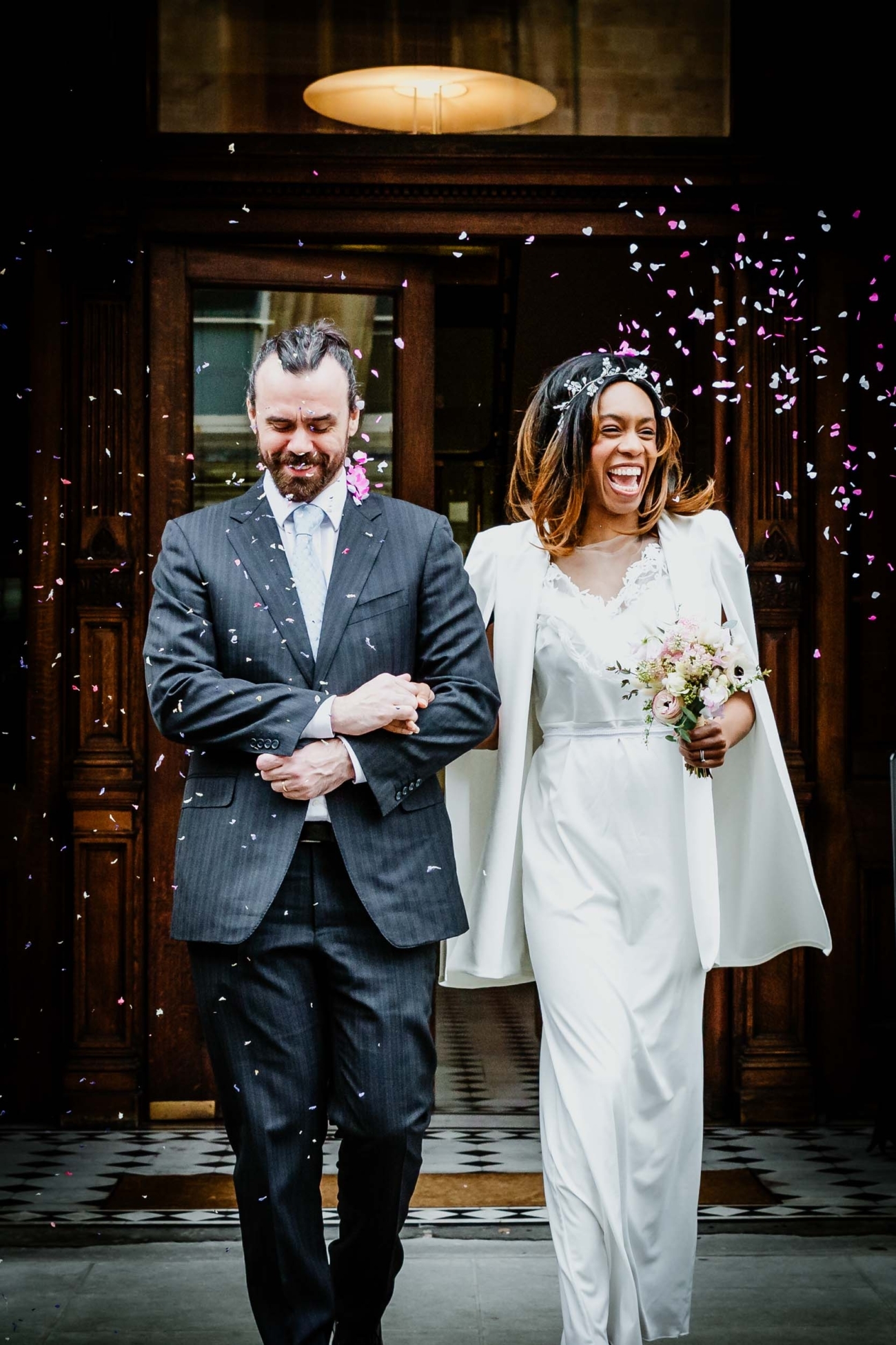 Documentary wedding photography of a joyful confetti exit outside Bristol Register Office captured by a Bristol wedding photographer