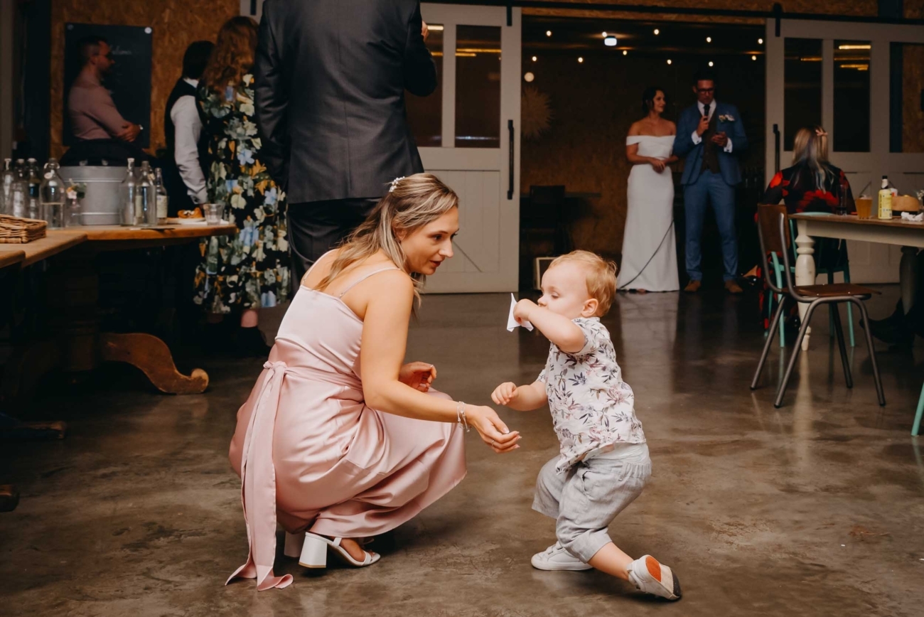 Documentary wedding photography in Bristol capturing a real moment of a child playing on the dance floor during the reception
