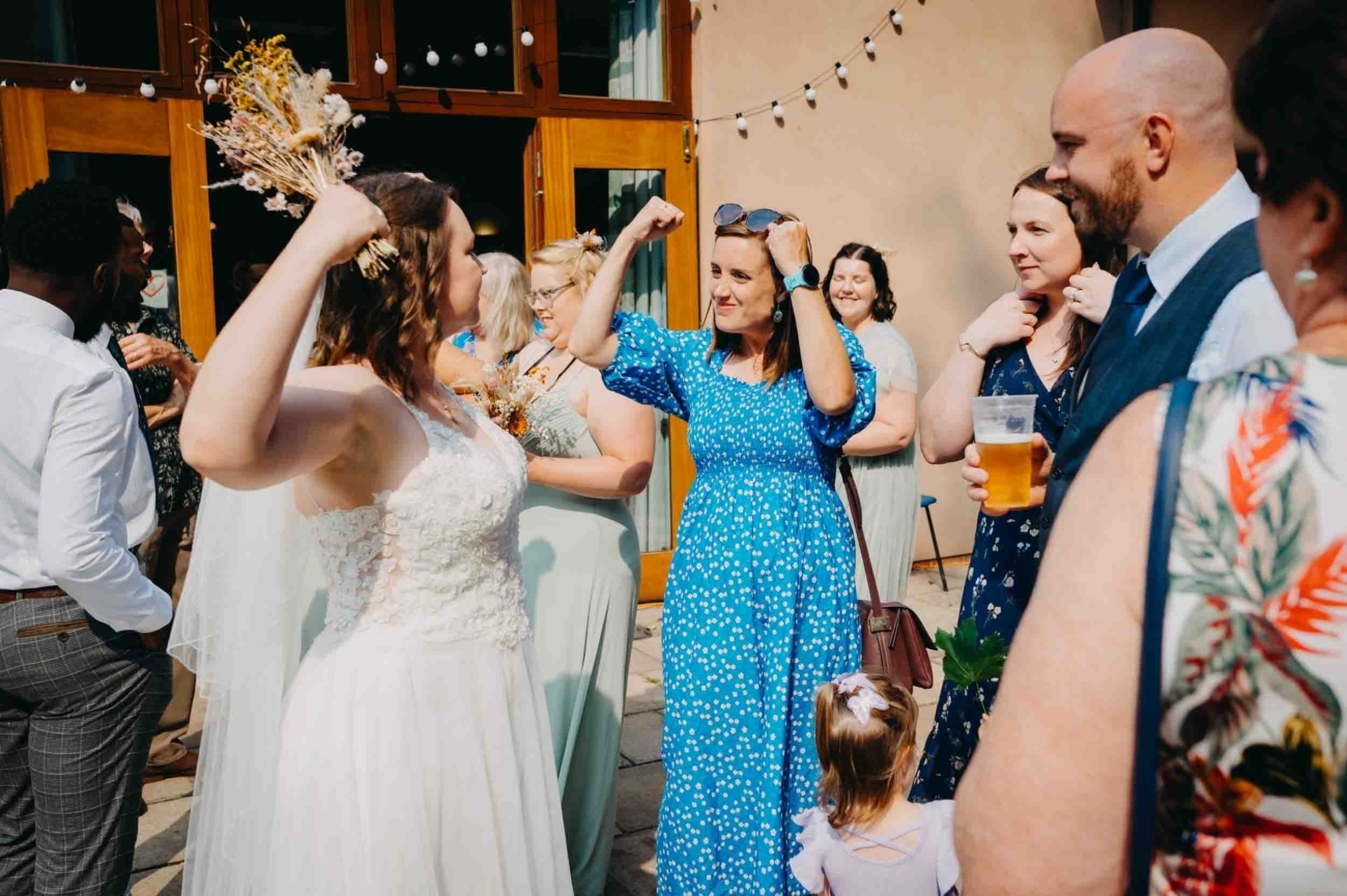 Candid wedding photography of guests celebrating at a wedding in Cheddon Fitzpaine near Taunton in Somerset by a Bristol wedding photographer