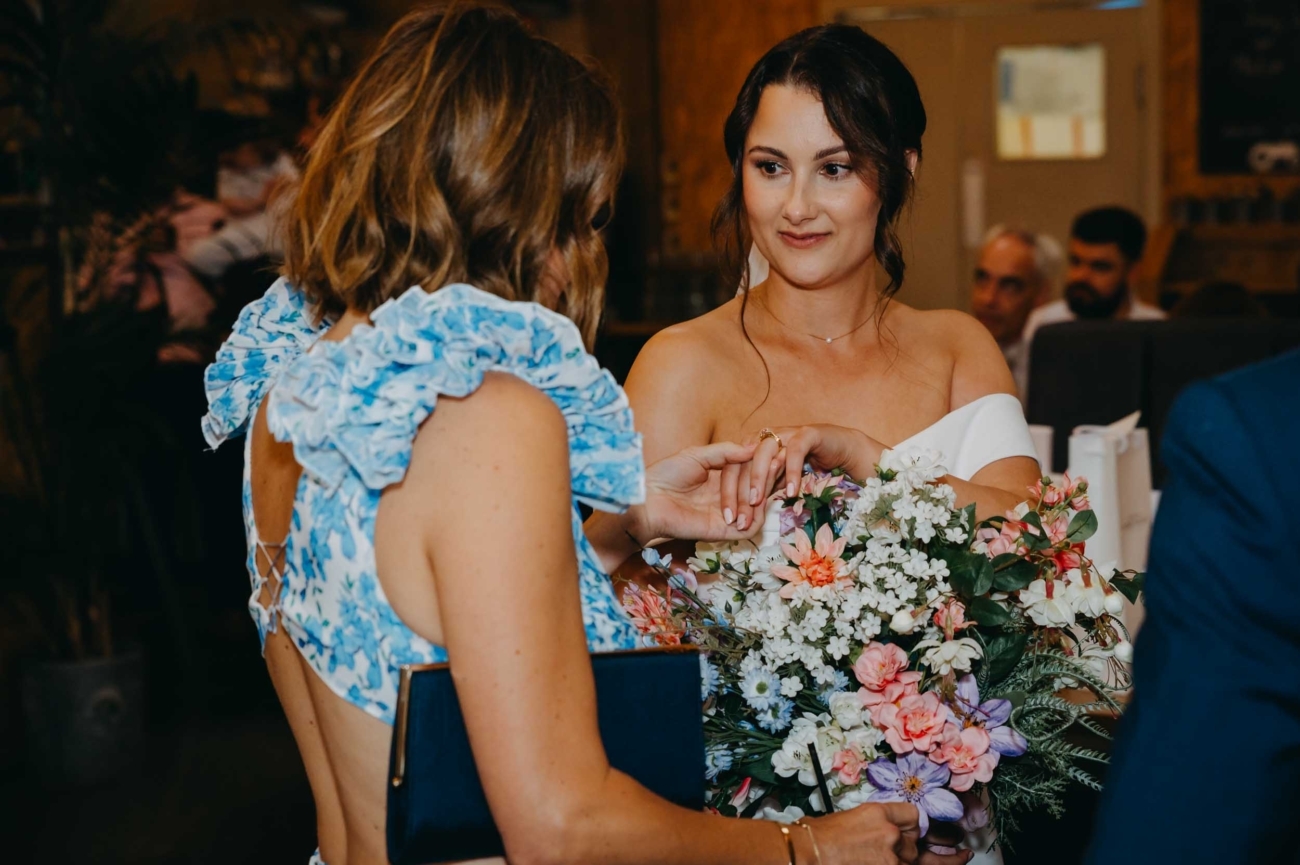 Documentary wedding photography capturing a ring moment during a wedding reception by a Bristol wedding photographer