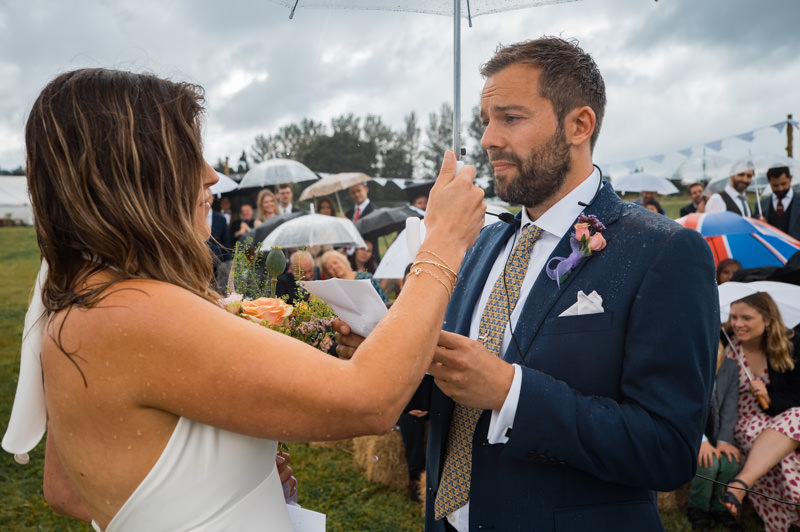 couple exchanging vows during outdoor wedding ceremony in South West countryside