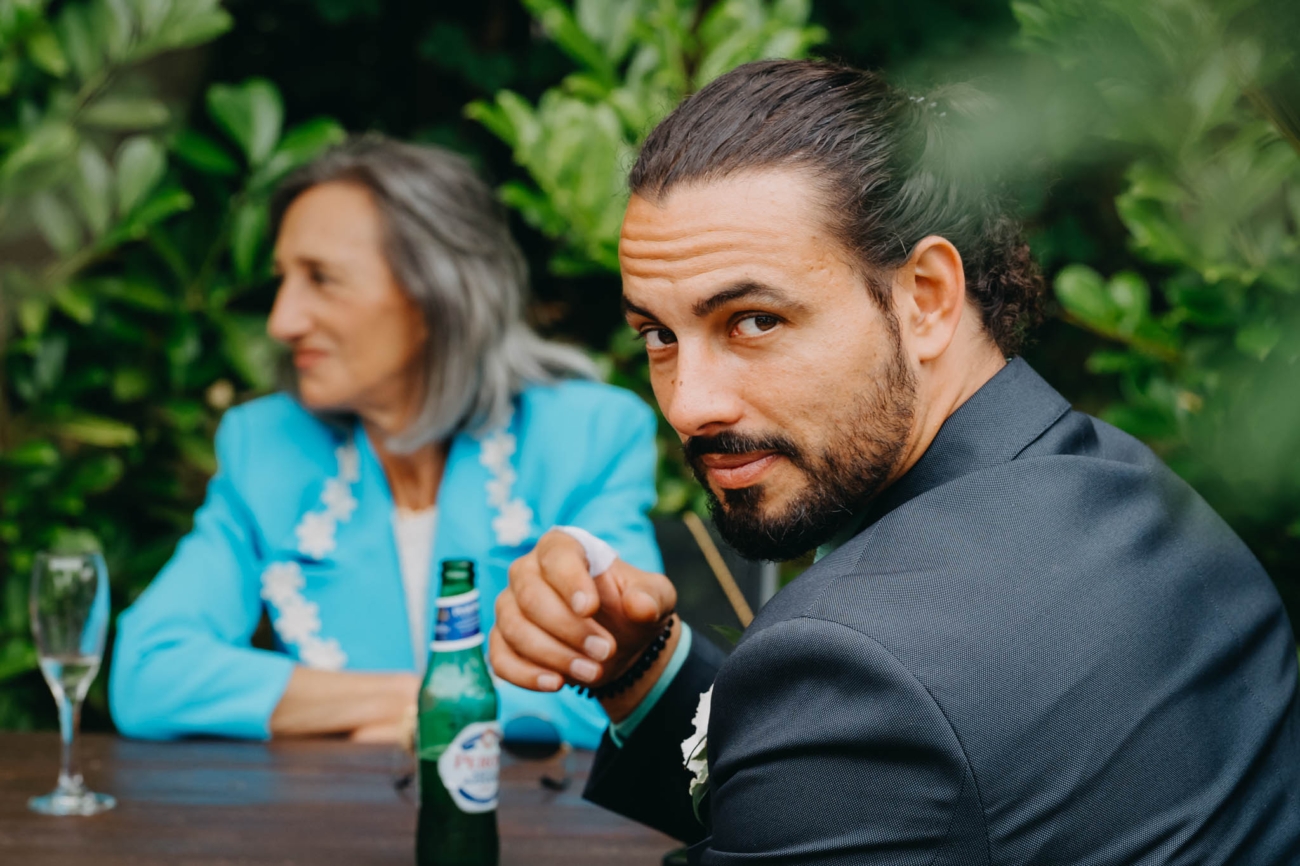 Wedding guest looking towards the camera while seated at an outdoor reception table