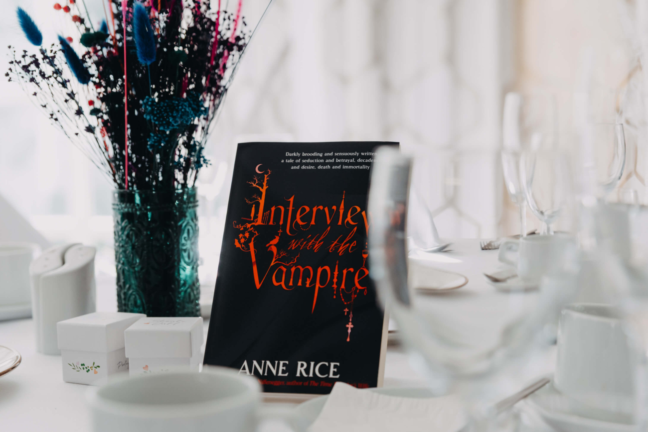 Wedding table decoration featuring Interview With The Vampire by Anne Rice, surrounded by colourful dried flowers